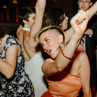 woman with short haircut in peach colored dress dancing