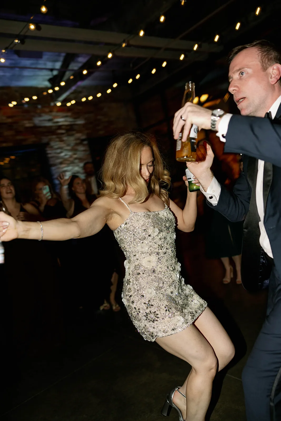 bride in short party skirt dancing