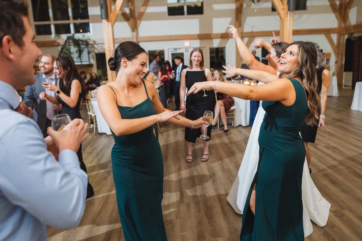 women in green dresses dancing at wedding