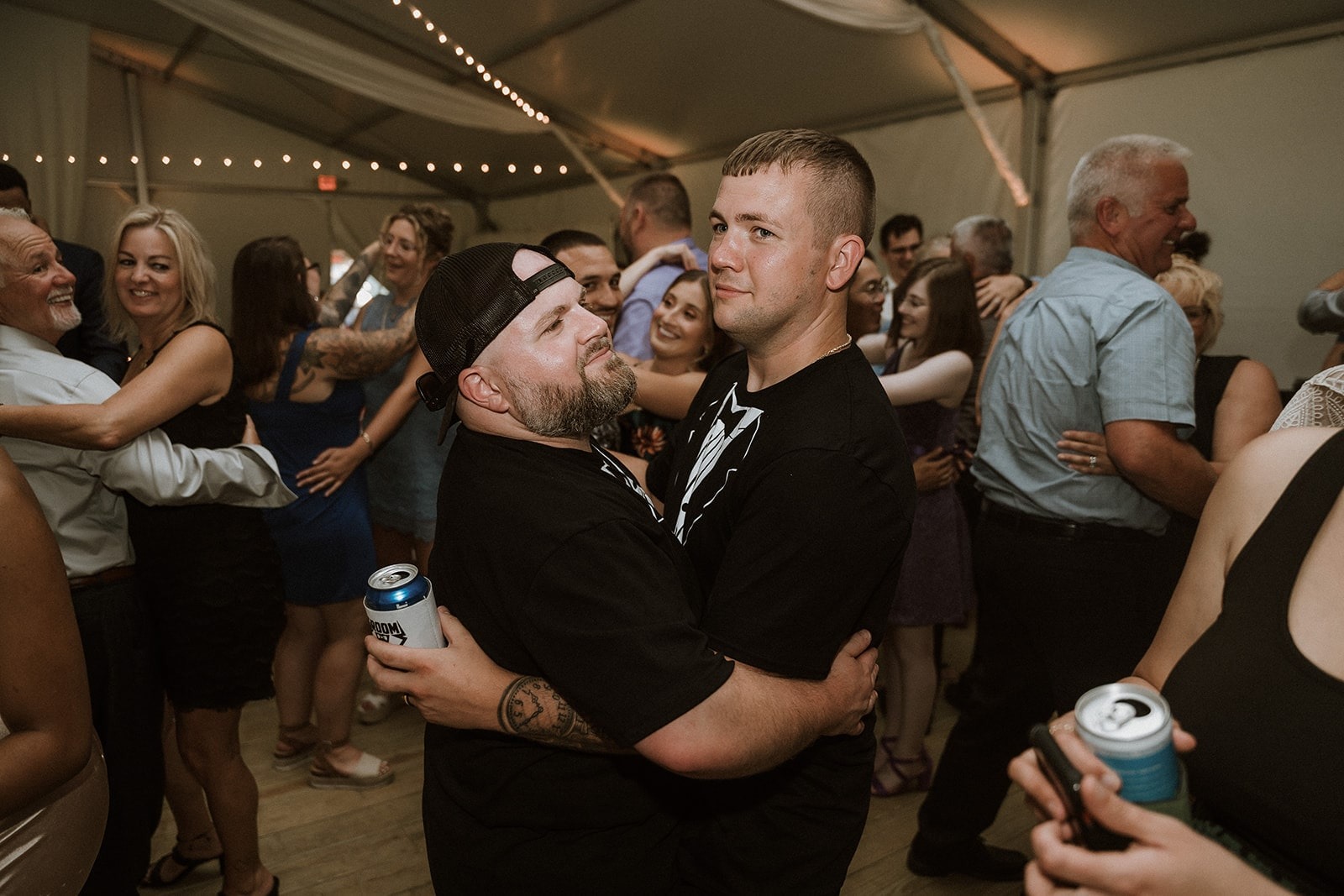 groom and groomsman slow dancing together