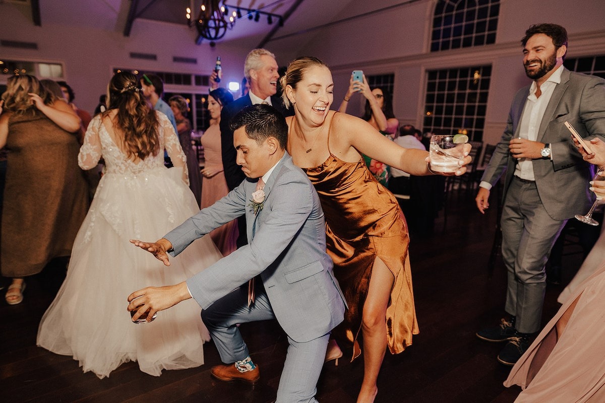 bridesmaid dancing behind groomsman