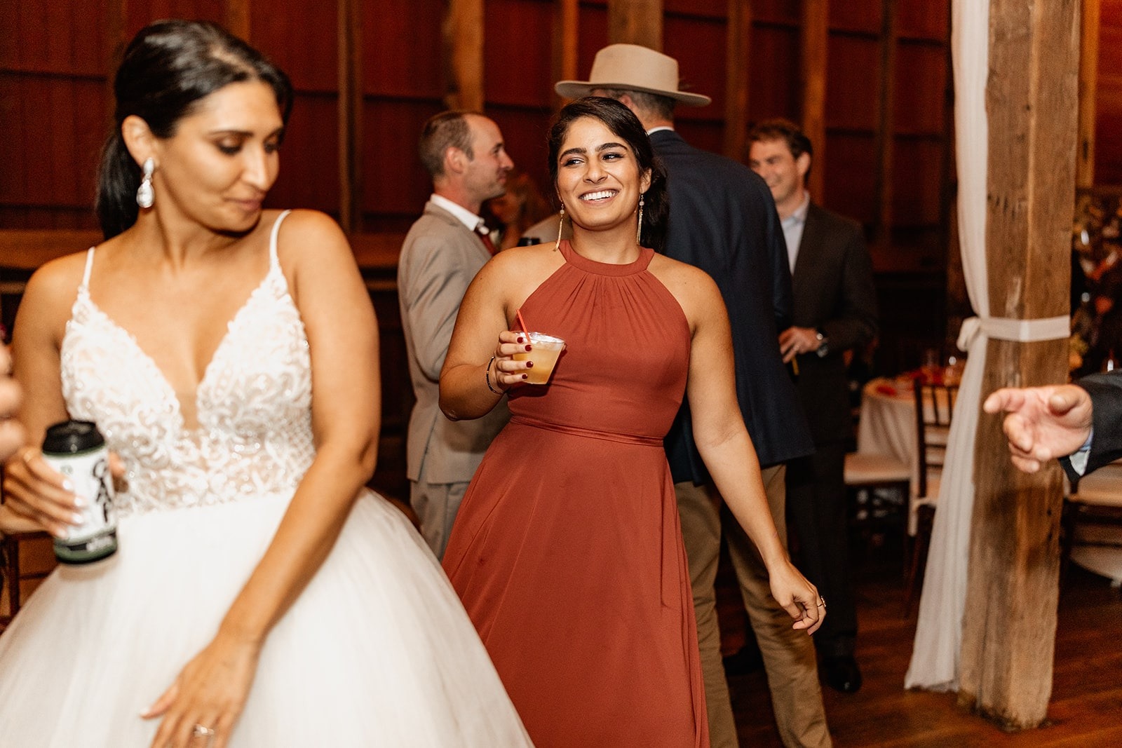 bride and maid of honor dancing at wedding