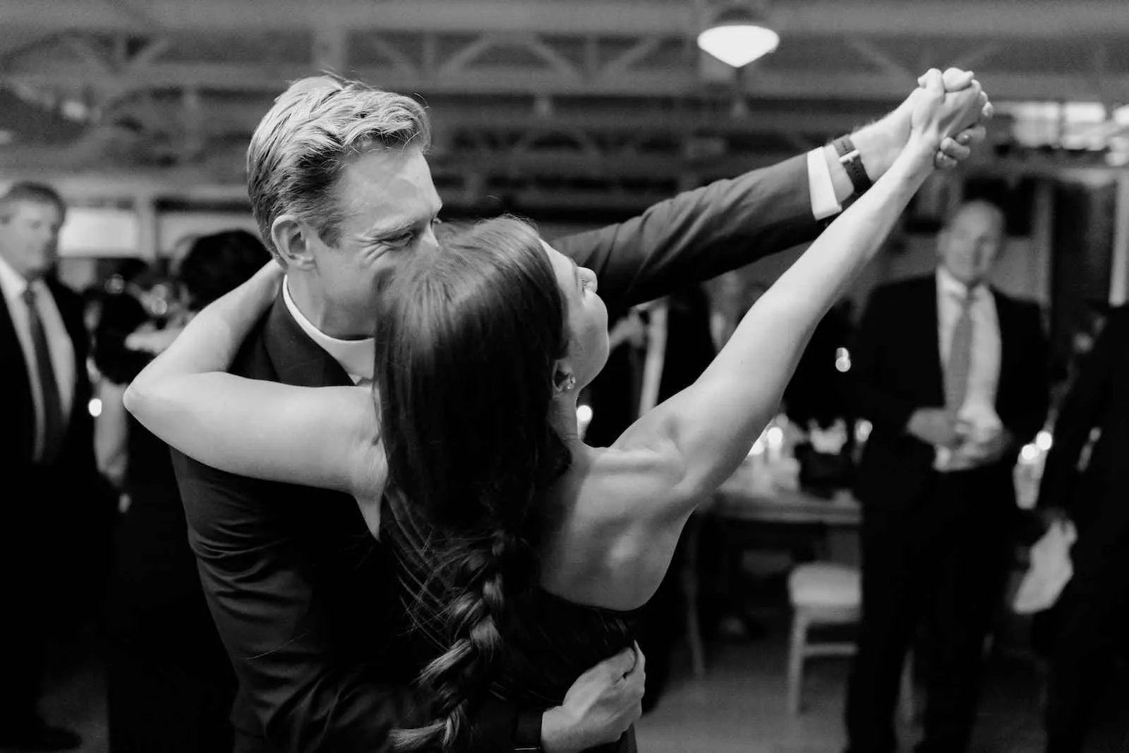 couple dancing tango style with arms outstretched at wedding