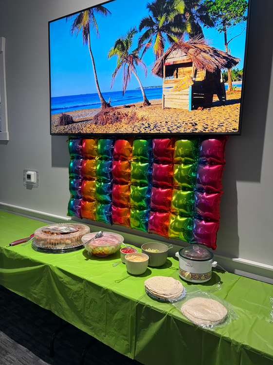 Large screens featuring photo slideshows above decorated table at the beaver pool house