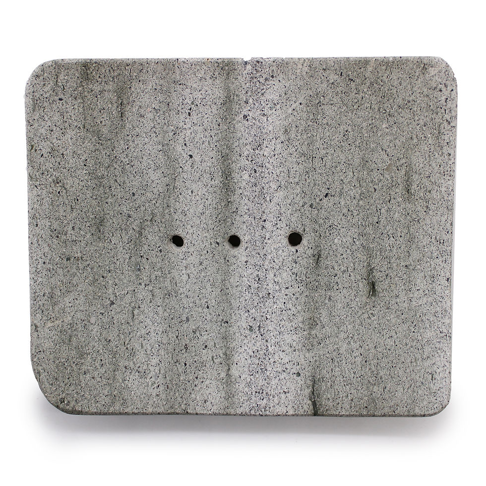 Close-up view of the soap dish's drainage holes and natural stone texture.