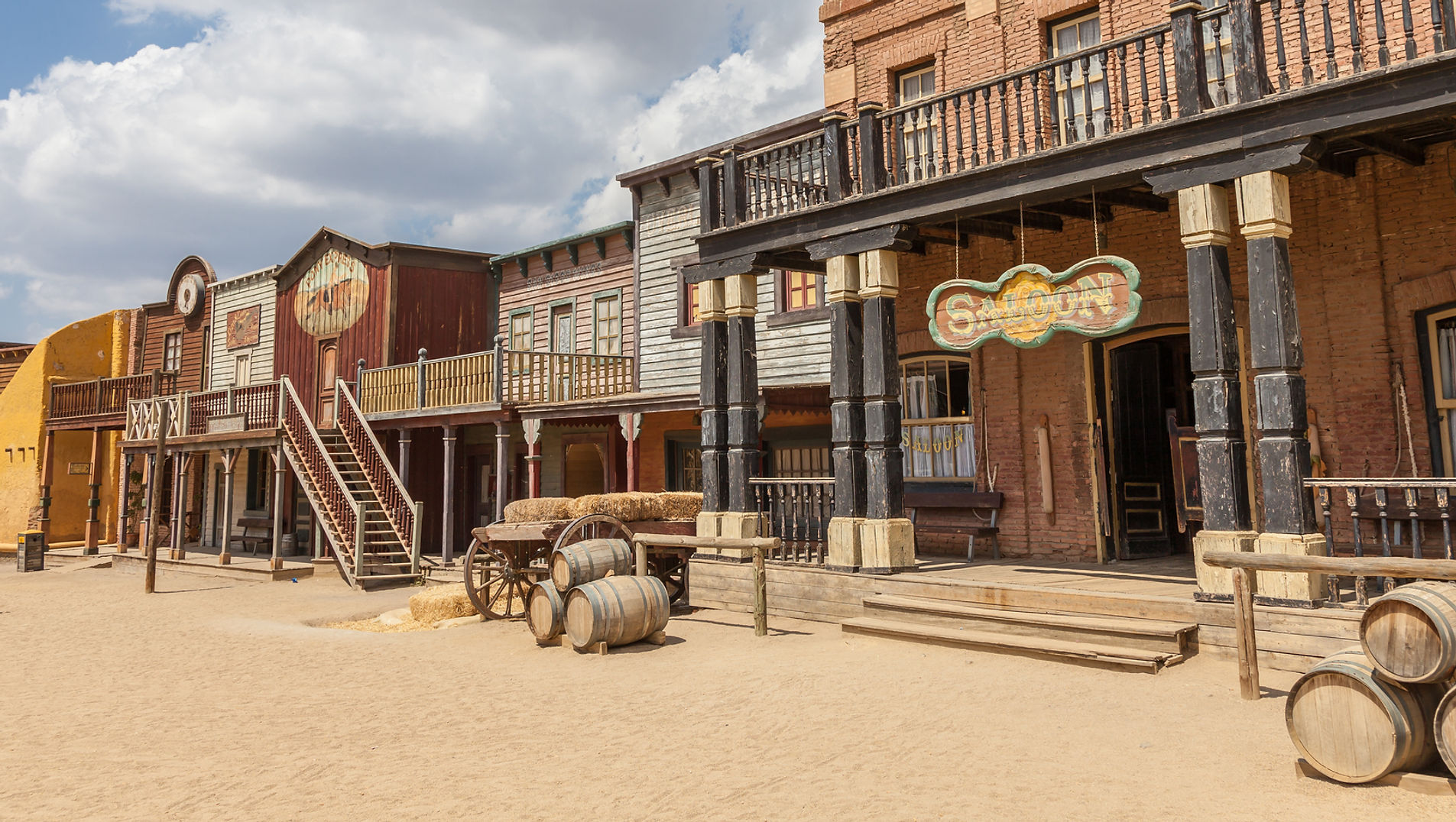 A historic Western town scene with frontier buildings and a dusty main street