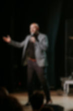 Christian nonprofit founder Justin Hayslett speaking at a leadership conference on purpose and calling