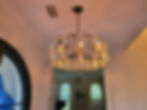 Modern crystal drum chandelier hanging in an entryway