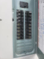 Open electrical service panel with circuit breakers.