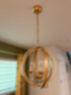 Gold orb chandelier hanging from the ceiling.