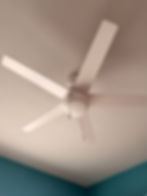 Modern white four-blade ceiling fan.