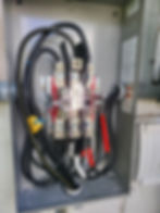 Open electrical panel with thick black wiring wiring
