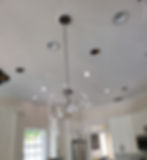 Modern glass pendant light hanging from a white ceiling