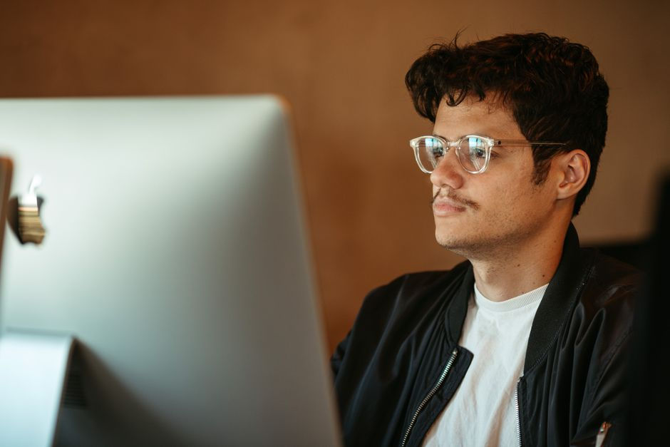adult squinting screen office