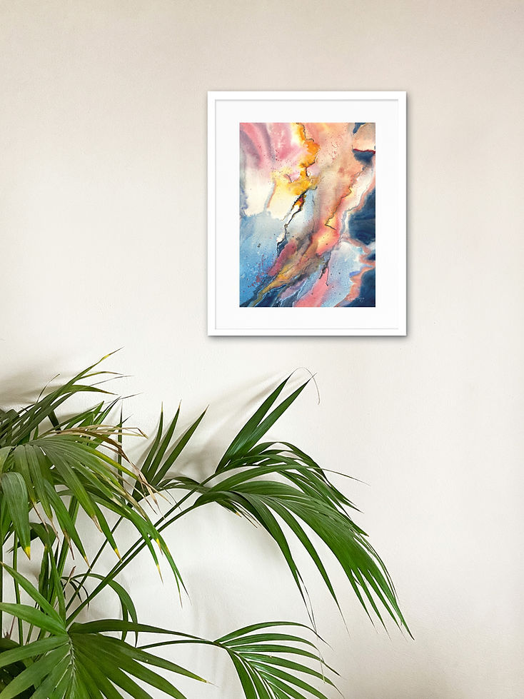 Original abstract watercolour painting Pulse displayed in a white frame on a light wall above a green palm plant.