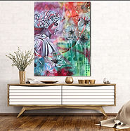 art on wall over a table with flowers in a vase  Art by Tina Lawver