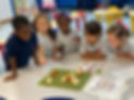 pre K students huddle.jpeg