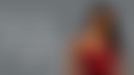 Mulher latina, modelo Maxi Steel, com joias em aço inoxidável e flores vermelhas, apresenta guia "Segredo Revelado: Como criar uma coleção de semijoias de sucesso?". Ideal para revendedoras de acessórios femininos em busca de dicas e inspiração.