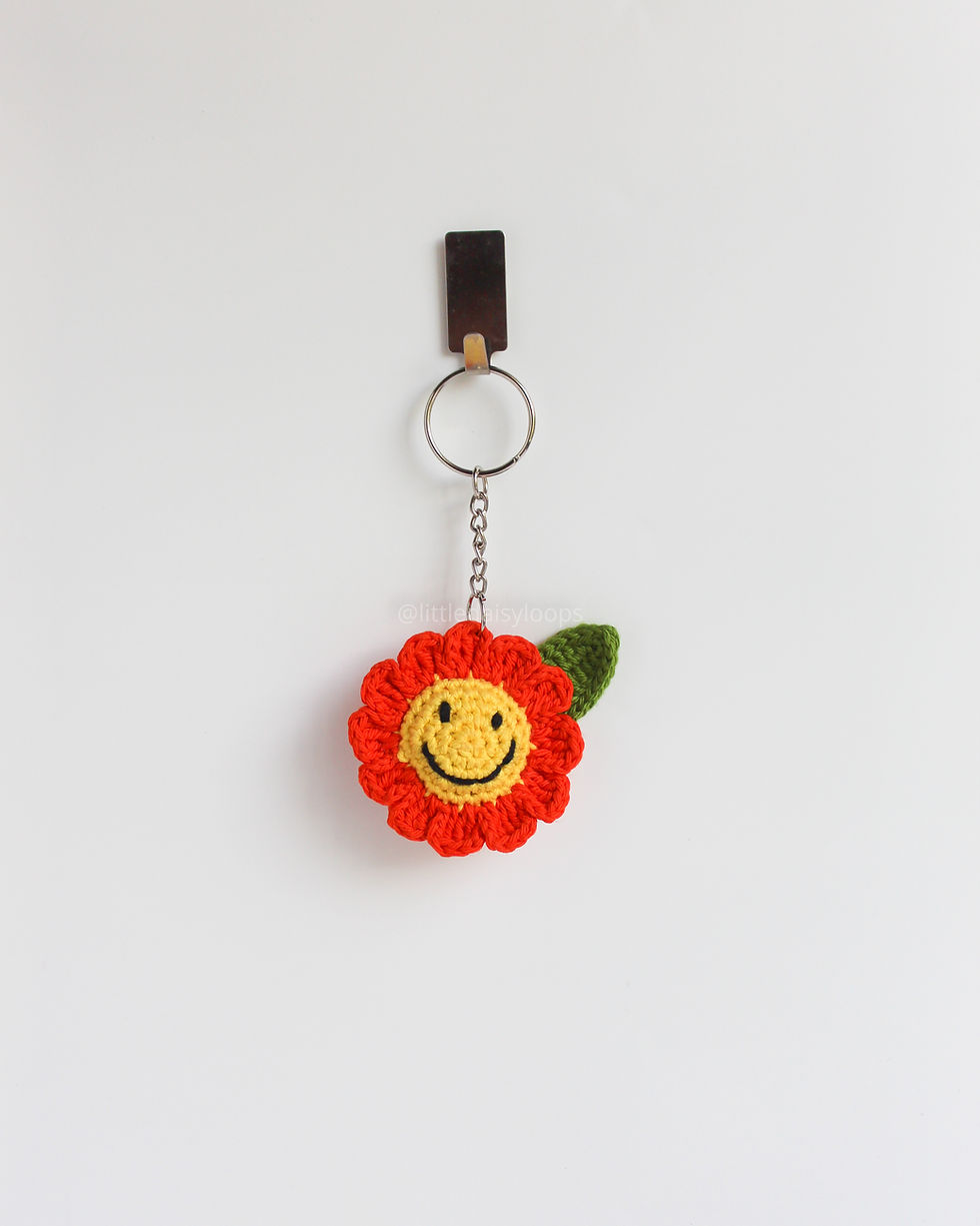 Handmade orange daisy smiley crochet keychain, crafted with soft premium cotton yarn, cute and colorful accessory for bags.