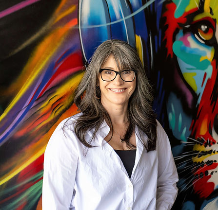 Carolyn Sharp against a colorful background