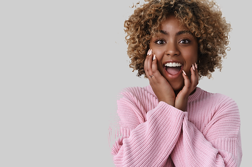 studio-shot-amused-excited-good-looking-african-female-with-fair-curly-hair-smiling-droppi