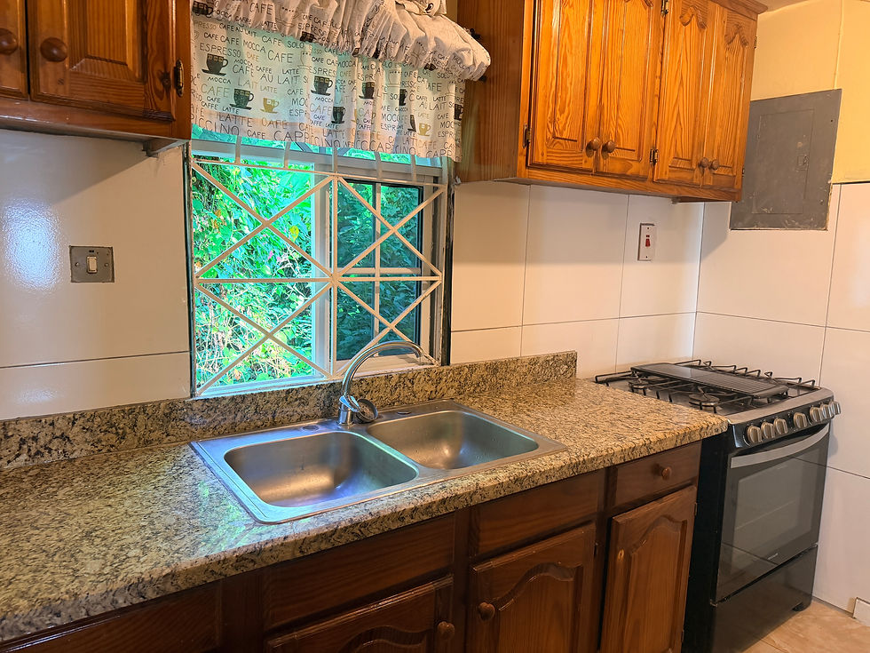 Picture of kitchen with modern granite countertops and full size stove