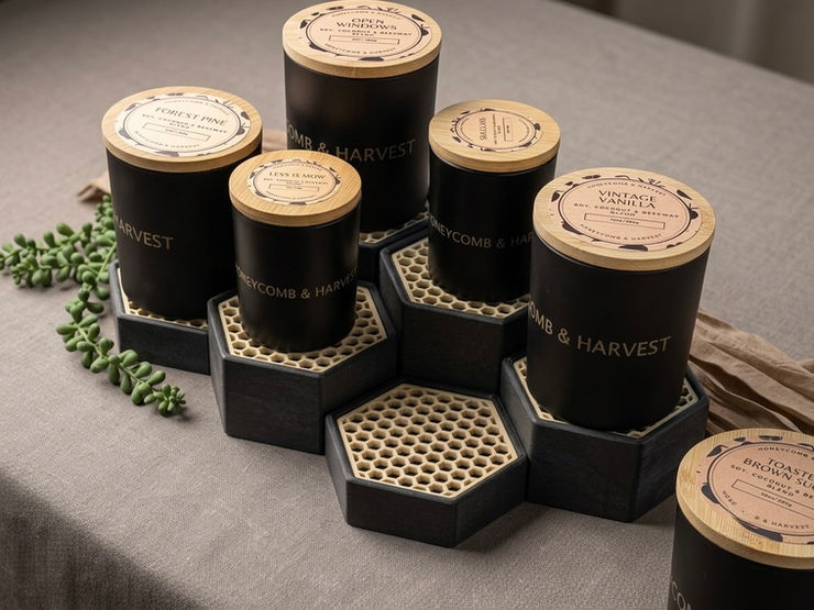 A warm and inviting display of handcrafted honey jars and beeswax candles on a rustic wooden table.