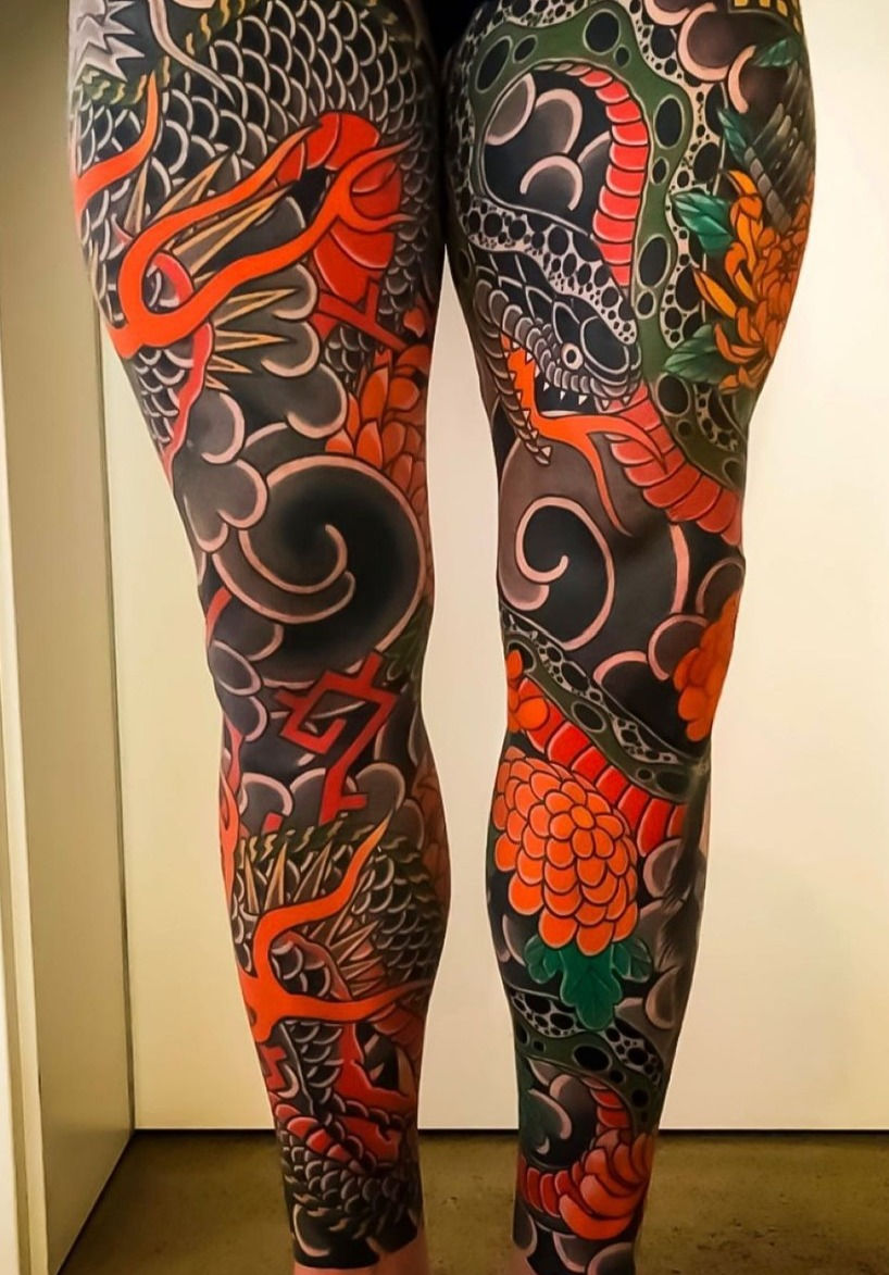 A mesmerizing Japanese leg sleeve tattoo unfurls, merging traditional motifs