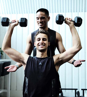 Strength trainer with client performing a vertical push motion.
