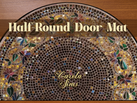 CarolaSim's Boho Half-Round Doormat, a mosaic-patterned half-round door mat with floral design on a wooden floor. Text reads "Half-Round Door Mat" and "CarolaSims."