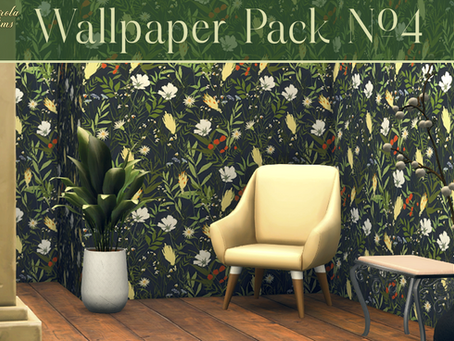 Cream chair next to a potted plant on wooden floor. Floral-patterned wallpaper with vibrant greens, white, and red. Cozy, inviting space.
