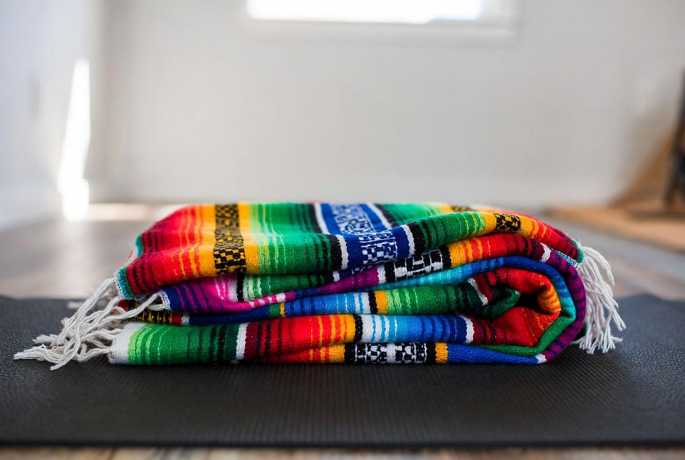 Colorful yoga blanket on a black yoga mat