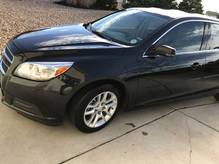 Side View of Black 2014 Chevy Malibu