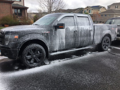Black Ford F-150 covered with car shampoo