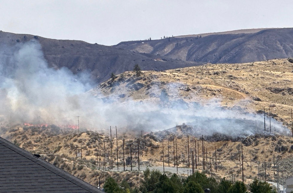Suburban Chelan wildfire temporarily closes highways, threatens power lines
