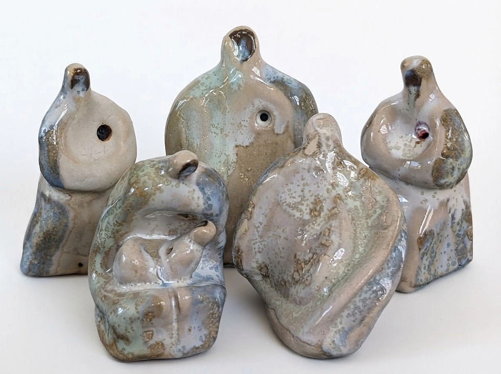 Five handmade stoneware sculptures with abstract human forms and earthy, mottled glazes