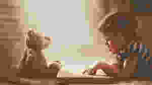 boy reading to teddy