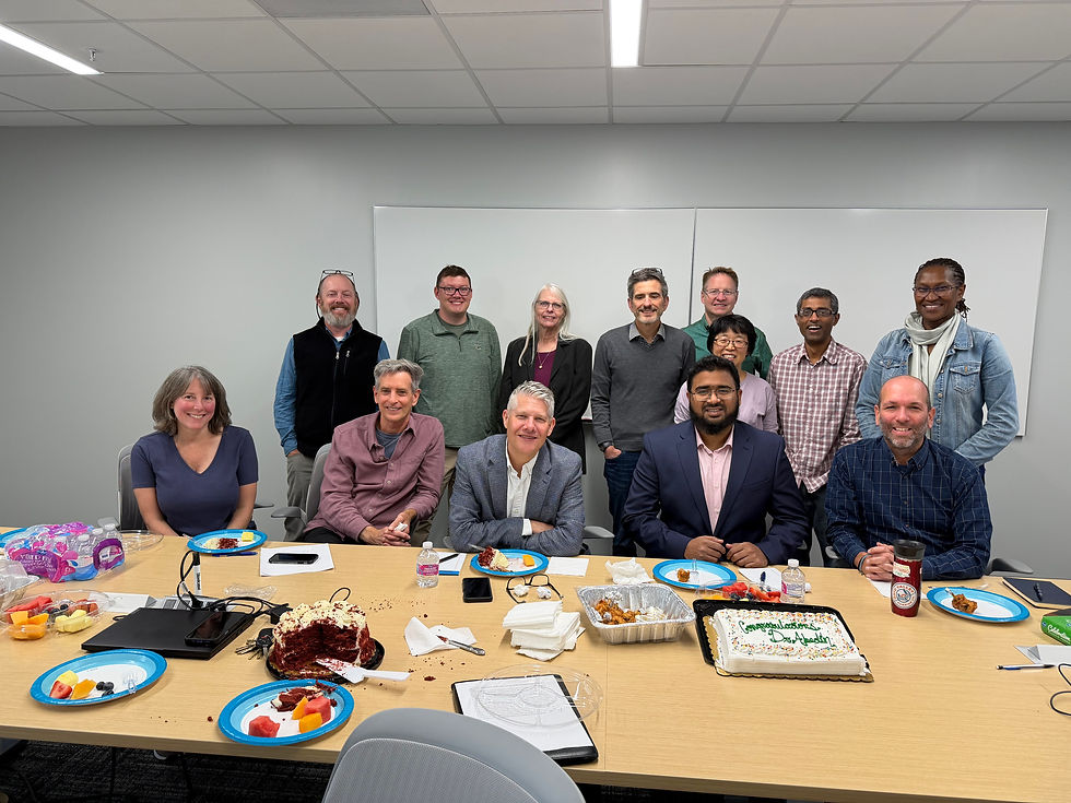 Faculty members in the Department of Geography at Ohio University celebrates Joynal's successful dissertation defense