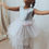 Thumbnail: A handmade sequin tutu dress with a silver sequin top and a pastel rainbow tutu skirt that falls just below the knee. The perfect flower girl, birthday dress or Christmas party dress
