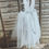 Thumbnail: A handmade grey tutu dress with a heart cut out back and has sparkly grey ankle length tulle skirt. It features a grey ribbon bow sash. Perfect flower girl or Holy communion dress
