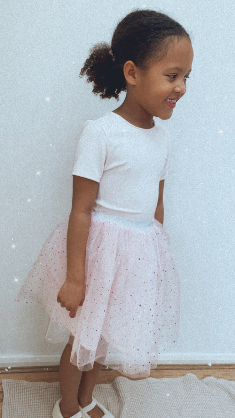 Thumbnail: A handmade blush tutu skirt and fitted cap sleeve top. It features a soft blush tulle skirt that falls just below the knee. The perfect flower girl, birthday dress or Christmas party dress