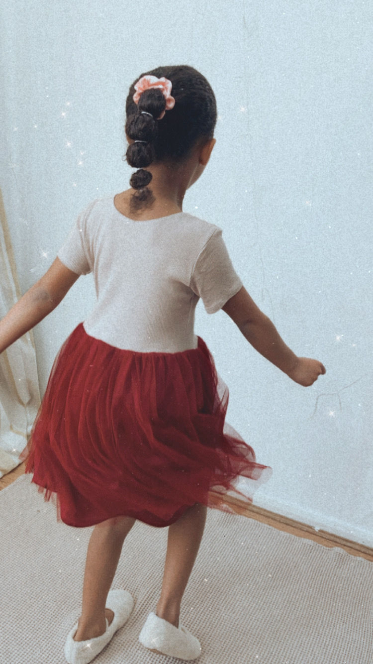 A handmade beige & red tutu dress with a beige cap sleeve top and a red tutu skirt that falls just below the knee. The perfect flower girl, birthday dress or Christmas party dress