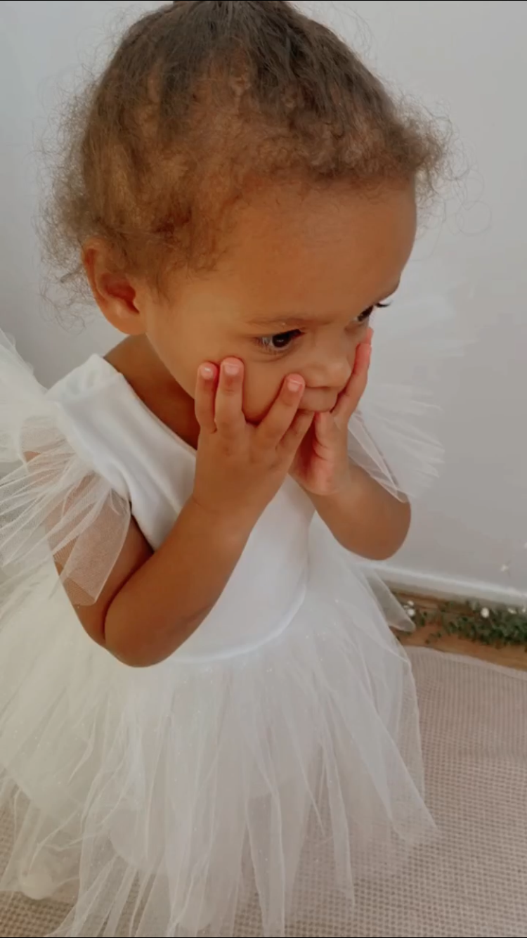 Thumbnail: A handmade sparkly ivory white velvet tutu dress with soft tulle frill sleeves. It features a sparkly tulle skirt that falls knee length. The perfect flower girl, birthday dress or Christmas party dress