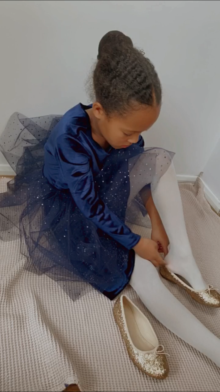 Thumbnail: A handmade navy velvet tutu dress with long sleeves. It features a sparkly navy tulle skirt that falls knee length. The perfect flower girl, birthday dress or Christmas party dress