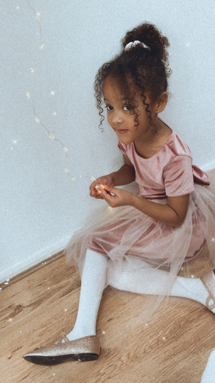 Thumbnail: A handmade blush pink velvet tutu dress with cap sleeves and a large velvet bow. It features a soft blush pink tutu skirt that falls just below the knee. The perfect flower girl, birthday dress or Christmas party dress