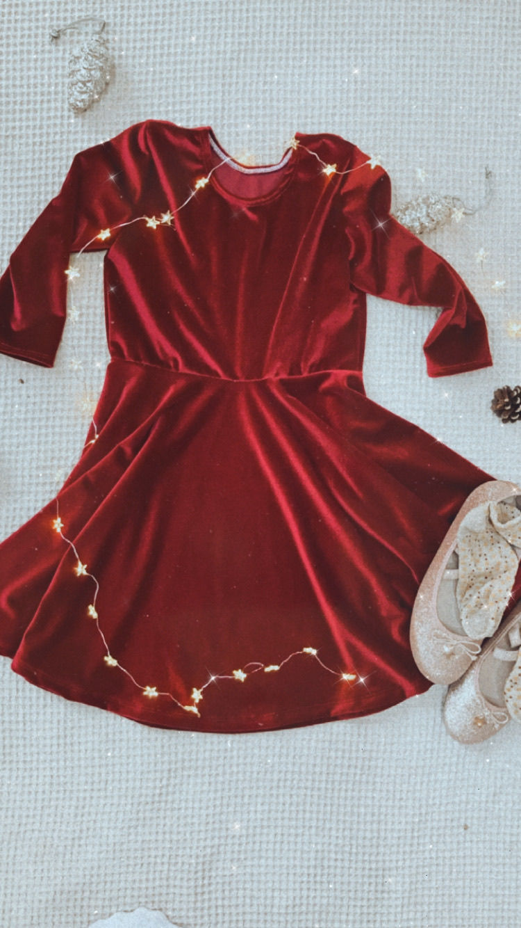 Thumbnail: A handmade red velvet skater dress with long sleeves. The dress falls just below the knee. The perfect flower girl, birthday dress or Christmas party dress