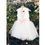 Thumbnail: A handmade ivory white tutu dress with a heart cut out back. It features a sparkly tulle skirt that falls knee length, and has a large duchess satin bow sash. The perfect flower girl, birthday dress or Christmas party dress