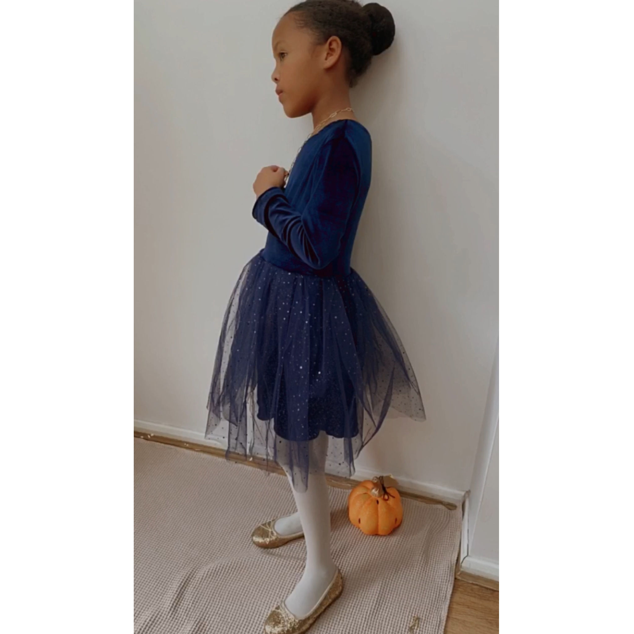 A handmade navy velvet tutu dress with long sleeves. It features a sparkly navy tulle skirt that falls knee length. The perfect flower girl, birthday dress or Christmas party dress
