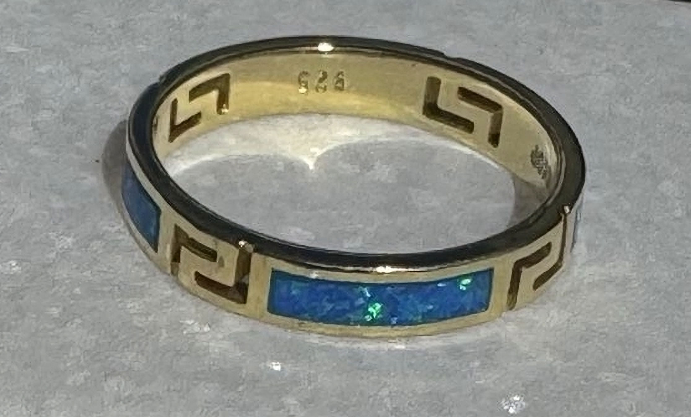 Gold Greek key ring with vivid blue opal inlay, symbolizing eternity and Greek craftsmanship