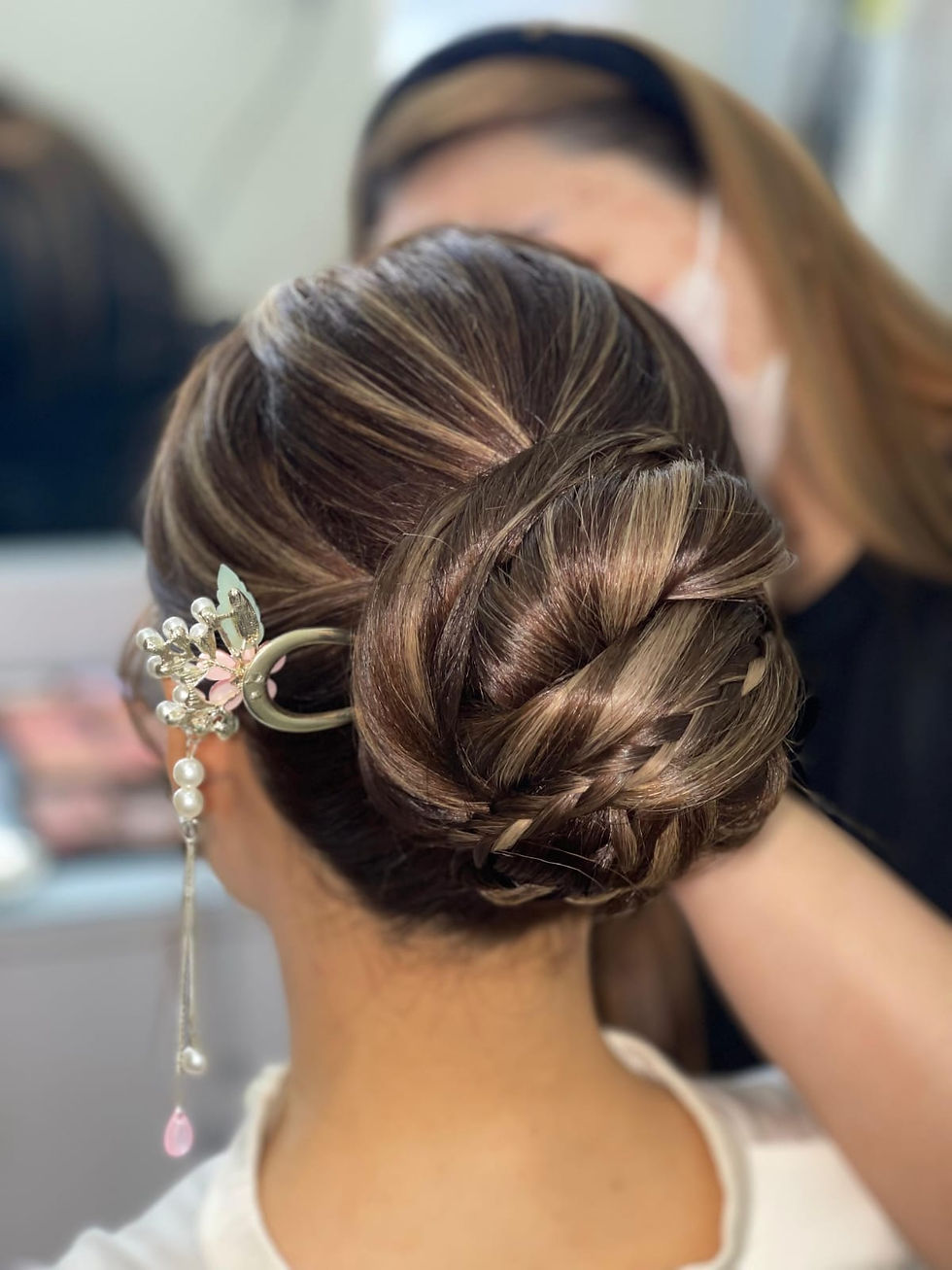 Intricate braided bun with floral hairpiece